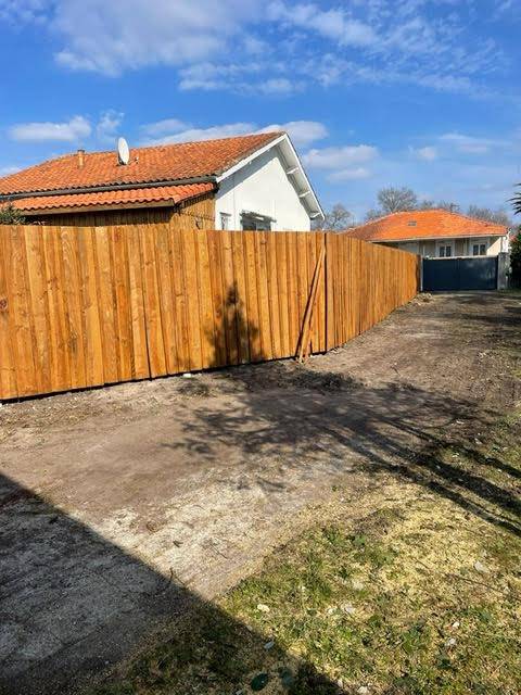 Poseur de clôture en bois volige avec couvertines en aluminium vers Arès 33